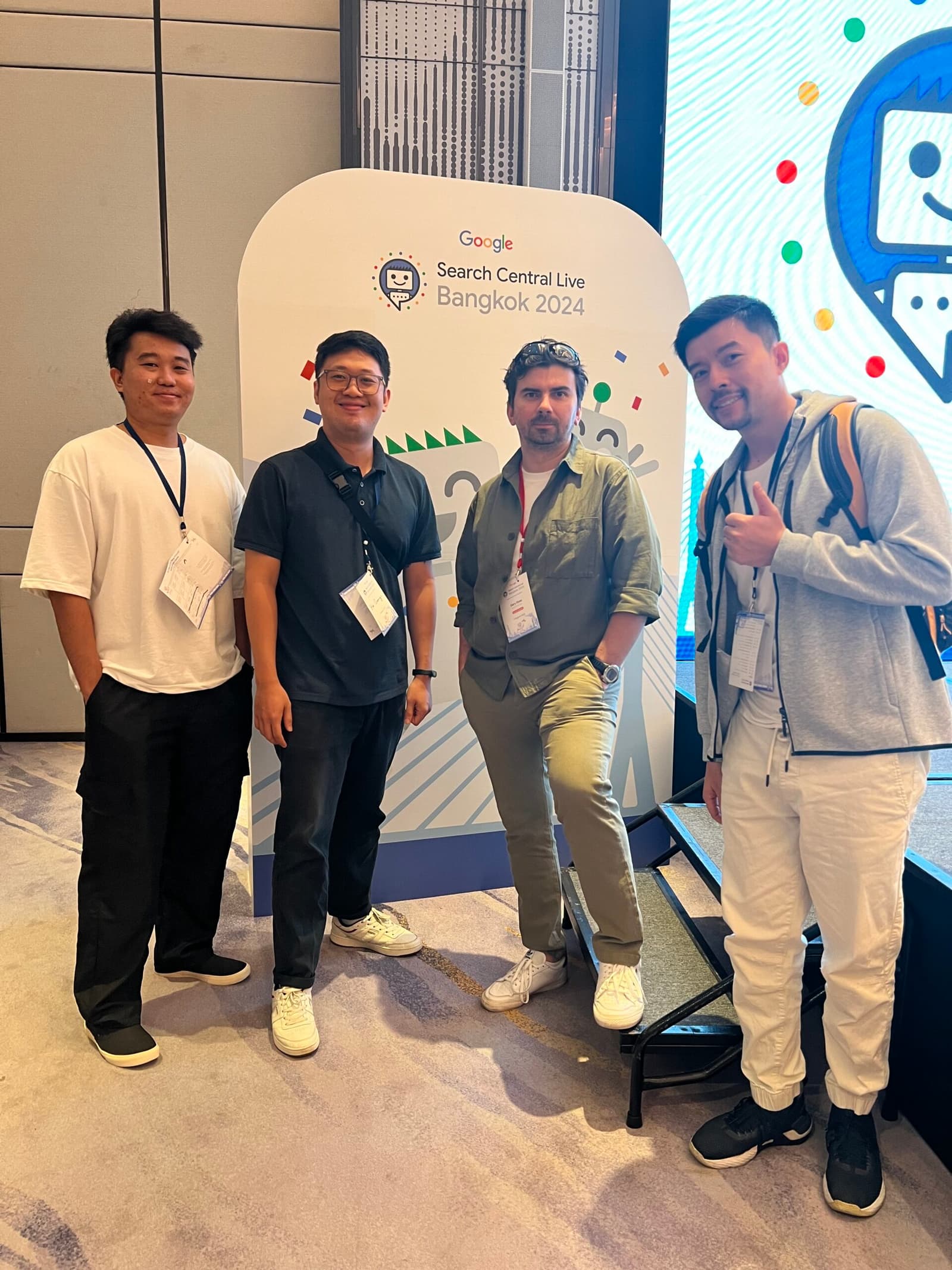 Four men pose next to the Google Search Central Live Bangkok 2024 sign.
