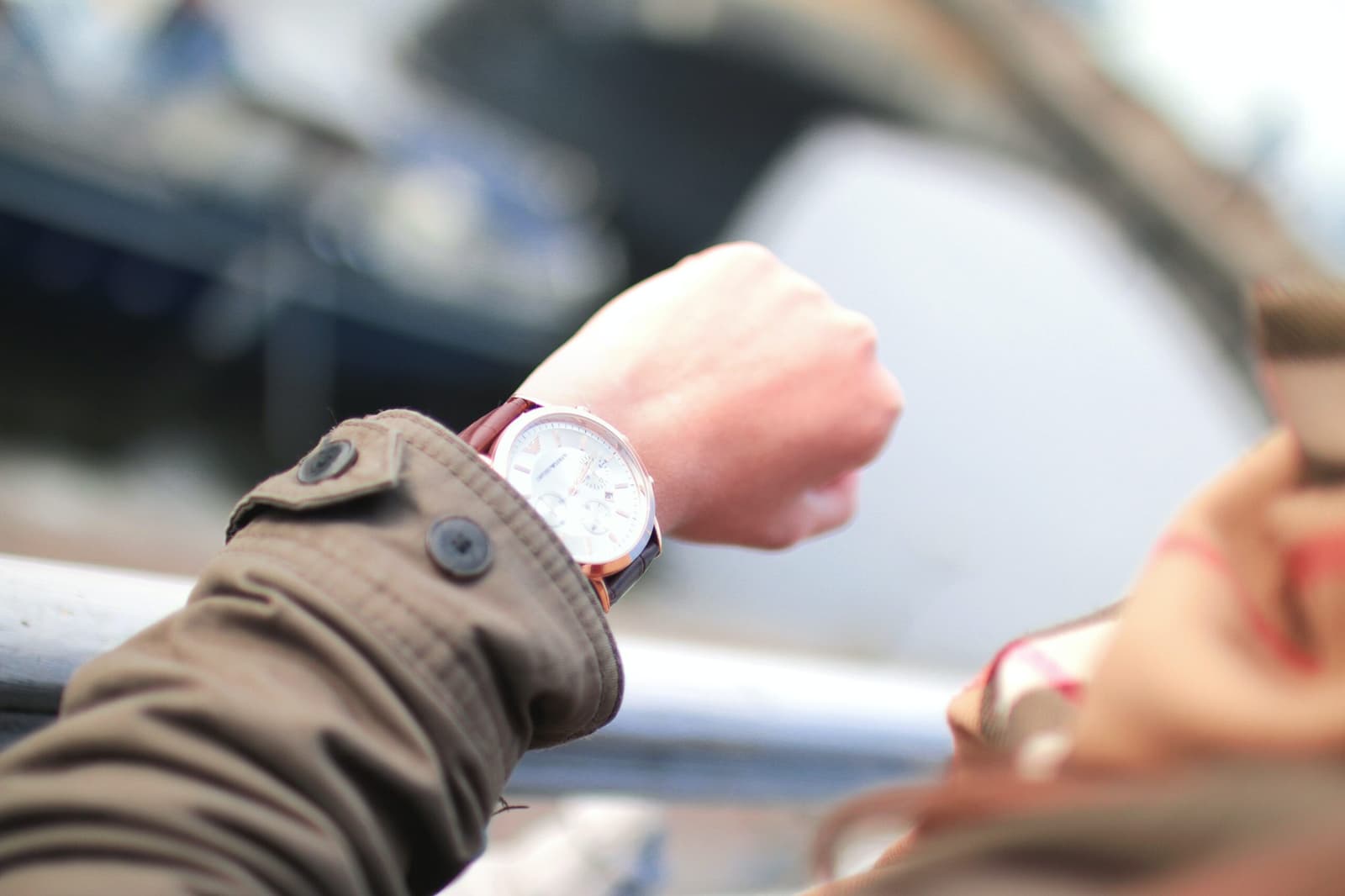 A person checking the time on their wristwatch.